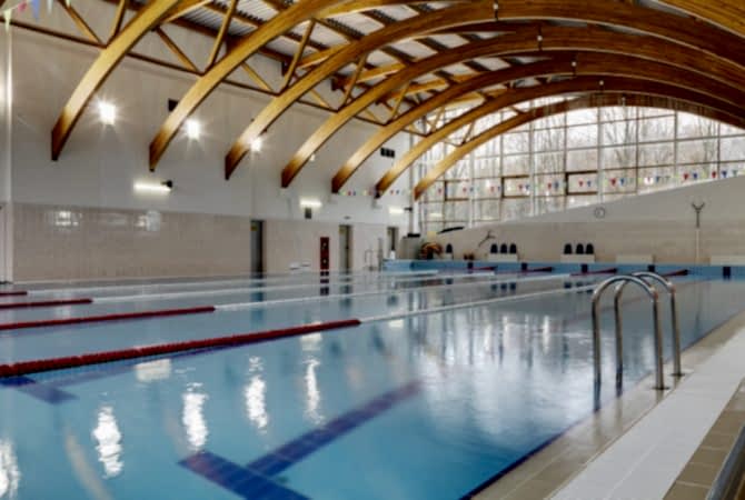 Indoor swimming pool with marked lanes, flat calm water